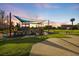 Vibrant community playground featuring play structures, picnic tables, and ample green space for outdoor fun and recreation at 400 Base E Ave # 213, Venice, FL 34285