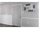 Hallway with grey walls, dark wood floors, mirror and white trim at 400 Base E Ave # 213, Venice, FL 34285