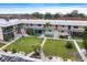 Two-story condo building showcasing well-maintained landscaping and walkways at 400 Base E Ave # 213, Venice, FL 34285
