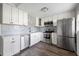 Updated kitchen with stainless steel appliances, modern cabinets, and decorative backsplash at 400 Base E Ave # 213, Venice, FL 34285