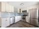 Modern kitchen with stainless steel appliances and updated cabinetry and backsplash at 400 Base E Ave # 213, Venice, FL 34285