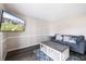 Cozy living room featuring a stylish couch and a TV mounted on the wall at 400 Base E Ave # 213, Venice, FL 34285