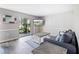 Comfortable living room featuring a couch, coffee tables, and a sliding glass door to the patio at 400 Base E Ave # 213, Venice, FL 34285