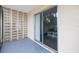 Outdoor patio with decorative cement block and sliding glass door leading inside at 400 Base E Ave # 213, Venice, FL 34285