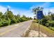 Roadside view of a paved trail and a community park sign at 400 Base E Ave # 213, Venice, FL 34285