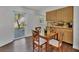 Cozy dining area adjacent to the kitchen, featuring a wooden table with four chairs at 409 Manatee Ct # 104, Venice, FL 34285