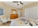 Inviting bedroom with a ceiling fan, natural light, and a spacious closet for storage at 4301 Nizza Ct, Venice, FL 34293
