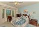 Cozy bedroom with lots of natural light and a pretty peacock-themed comforter at 4301 Nizza Ct, Venice, FL 34293