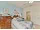 Charming bedroom with blue walls, complemented by an ensuite bathroom and stylish peacock bedding at 4301 Nizza Ct, Venice, FL 34293