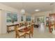 Charming dining room with decorative chandelier and views of the living area and backyard at 4301 Nizza Ct, Venice, FL 34293