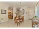 Cozy dining area featuring a chandelier, wood table, and easy access to the kitchen at 4301 Nizza Ct, Venice, FL 34293