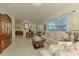 Spacious living room with tile floors, large windows, and open floor plan with seamless transitions to other spaces at 4301 Nizza Ct, Venice, FL 34293