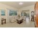 Comfortable living room showcasing tile floors, lots of light, and floral-patterned furniture at 4301 Nizza Ct, Venice, FL 34293