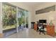 Bright home office with sliding glass doors leading to an outdoor seating area at 4301 Nizza Ct, Venice, FL 34293