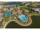 Aerial view of the community with tennis courts and pool overlooking a lake at 448 Bocelli Dr, Nokomis, FL 34275