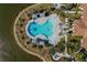 Aerial view of the community pool and waterfront, surrounded by lush greenery at 448 Bocelli Dr, Nokomis, FL 34275