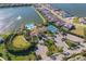 Stunning aerial view of the community clubhouse, pool, tennis courts, and lake at 448 Bocelli Dr, Nokomis, FL 34275