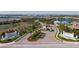 Aerial view of Aria community entrance featuring lush landscaping, water features, and a grand entry gate at 448 Bocelli Dr, Nokomis, FL 34275