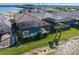Aerial view of a home with screened-in pool in a lakeside community with lush landscaping at 448 Bocelli Dr, Nokomis, FL 34275