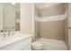 Bright bathroom with a shower-over-tub combination, light beige tiling and a white sink vanity at 448 Bocelli Dr, Nokomis, FL 34275