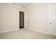 Empty carpeted bedroom with ensuite bathroom and neutral colored walls at 448 Bocelli Dr, Nokomis, FL 34275