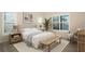 Brightly lit bedroom with plantation shutters, neutral color palette, and coastal decor at 448 Bocelli Dr, Nokomis, FL 34275