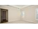 Bright empty bedroom with neutral carpet, plantation shutters, and ensuite bathroom at 448 Bocelli Dr, Nokomis, FL 34275
