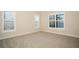 Well-lit bedroom featuring carpet floors, bright paint and plantation shutters at 448 Bocelli Dr, Nokomis, FL 34275