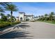 Elegant arched entrance gate lined with palm trees leading into the Aria community at 448 Bocelli Dr, Nokomis, FL 34275