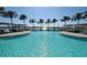 Stunning community pool with lake views, lounge chairs, and covered cabanas at 448 Bocelli Dr, Nokomis, FL 34275