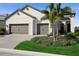 Stunning home exterior featuring a three-car garage, lush landscaping, and a well-manicured lawn at 448 Bocelli Dr, Nokomis, FL 34275