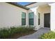 Inviting front entrance featuring a dark door framed by windows and vibrant landscaping at 448 Bocelli Dr, Nokomis, FL 34275