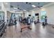 Bright fitness center with modern exercise equipment, weights, and mirrored wall at 448 Bocelli Dr, Nokomis, FL 34275