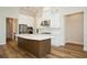 Modern kitchen with stainless steel appliances, white cabinetry, an oversized island, and ample counter space at 448 Bocelli Dr, Nokomis, FL 34275