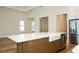 Modern kitchen island with a farmhouse sink, quartz countertop, and stainless steel appliances at 448 Bocelli Dr, Nokomis, FL 34275