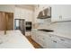 Bright kitchen features white cabinets, stainless steel appliances and a large island with marble countertops at 448 Bocelli Dr, Nokomis, FL 34275