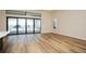 Bright living space with a sliding glass door leading to the pool area, complemented by hardwood floors at 448 Bocelli Dr, Nokomis, FL 34275