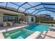 An outdoor dining and lounging area sits beside a screened pool and hot tub with brick pavers at 448 Bocelli Dr, Nokomis, FL 34275
