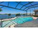 Lovely screened pool and spa overlooking the lake with brick pavers and relaxing outdoor space at 448 Bocelli Dr, Nokomis, FL 34275