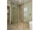 Modern shower with large glass door and pebble base at 448 Bocelli Dr, Nokomis, FL 34275