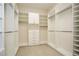 Expansive walk-in closet with custom white built-ins and ample storage space at 448 Bocelli Dr, Nokomis, FL 34275