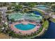 Aerial view of community pool, clubhouse, and tennis courts with surrounding landscape at 4802 51St W St # 1816, Bradenton, FL 34210