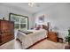 Comfortable bedroom with a ceiling fan, stylish furniture, and a bright window at 4802 51St W St # 1816, Bradenton, FL 34210