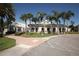 Exterior of clubhouse with manicured landscaping, large windows, and covered walkway at 4802 51St W St # 1816, Bradenton, FL 34210