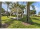 Outdoor gazebo with picnic table surrounded by lush grass and mature trees at 4802 51St W St # 1816, Bradenton, FL 34210