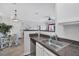 Open kitchen with a stainless steel dishwasher, sink, and a view to the living room at 4802 51St W St # 1816, Bradenton, FL 34210