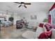 Bright living room featuring neutral walls, tile floors, modern ceiling fan, and comfortable furniture at 4802 51St W St # 1816, Bradenton, FL 34210