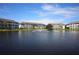 Community pond with fountain and surrounding apartments and clear blue skies at 4802 51St W St # 1816, Bradenton, FL 34210