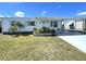 Single-story home with a manicured lawn, and a covered parking area to the right at 520 Tampico Dr, North Port, FL 34287