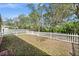 Well-maintained backyard enclosed by a classic white picket fence, providing privacy and charm at 5458 Jessamine Ave, North Port, FL 34291